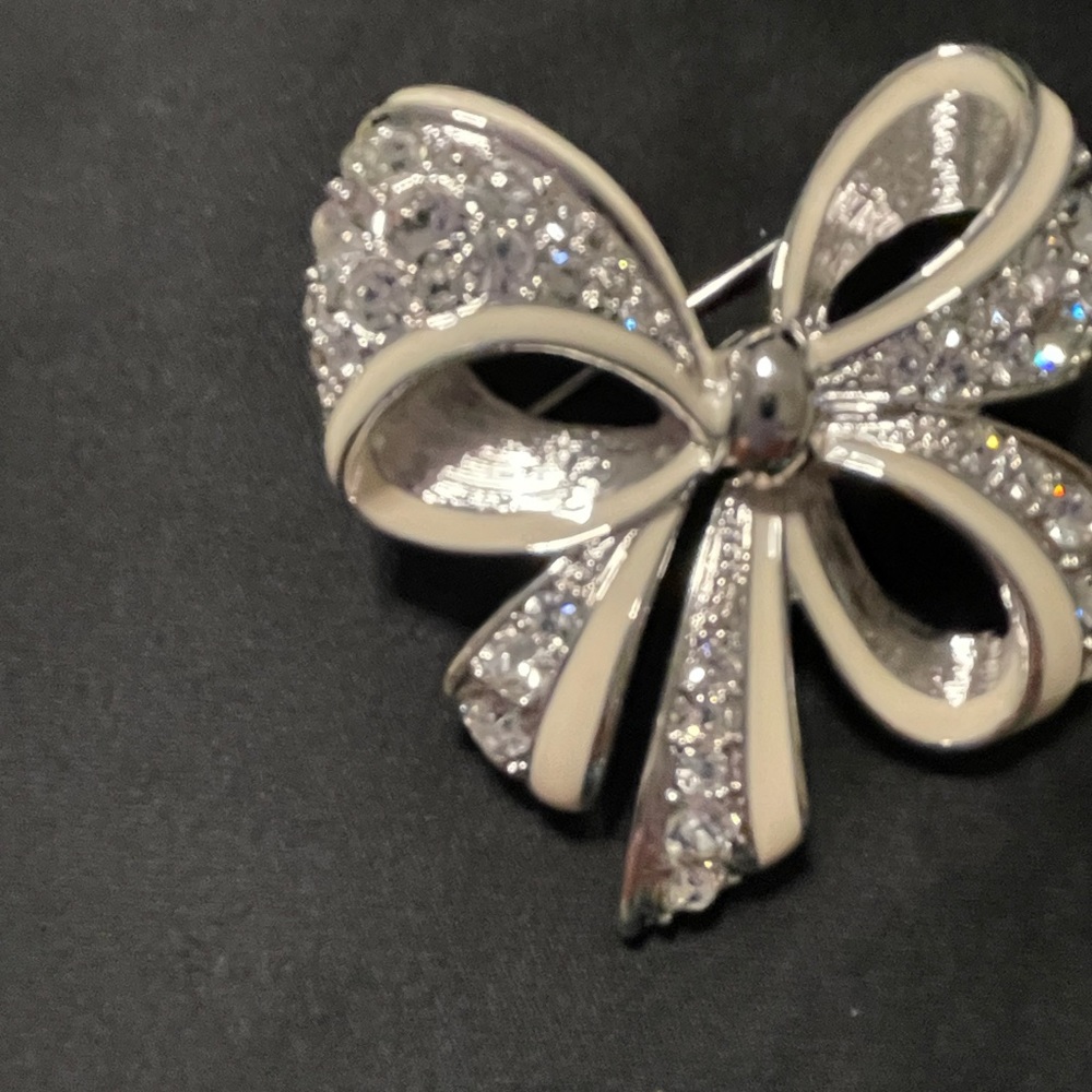 Nolan Miller silver rhinestone bow brooch.